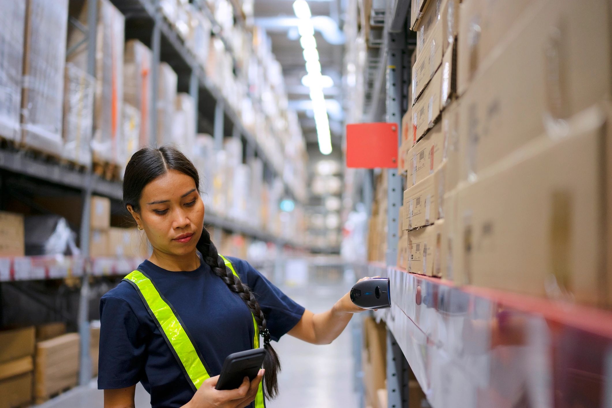 Employee using barcode scanner for inventory checking