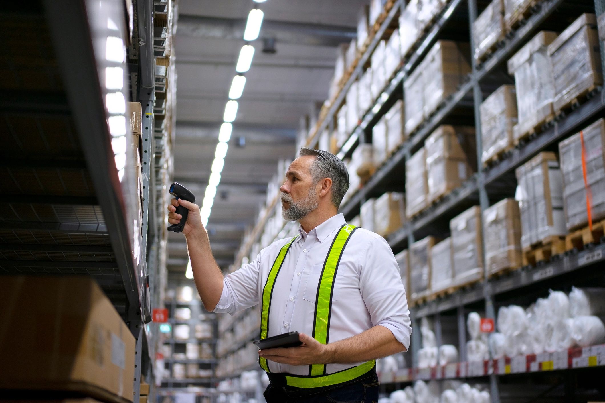 Warehouse staff checking merchandise with scanning equipment