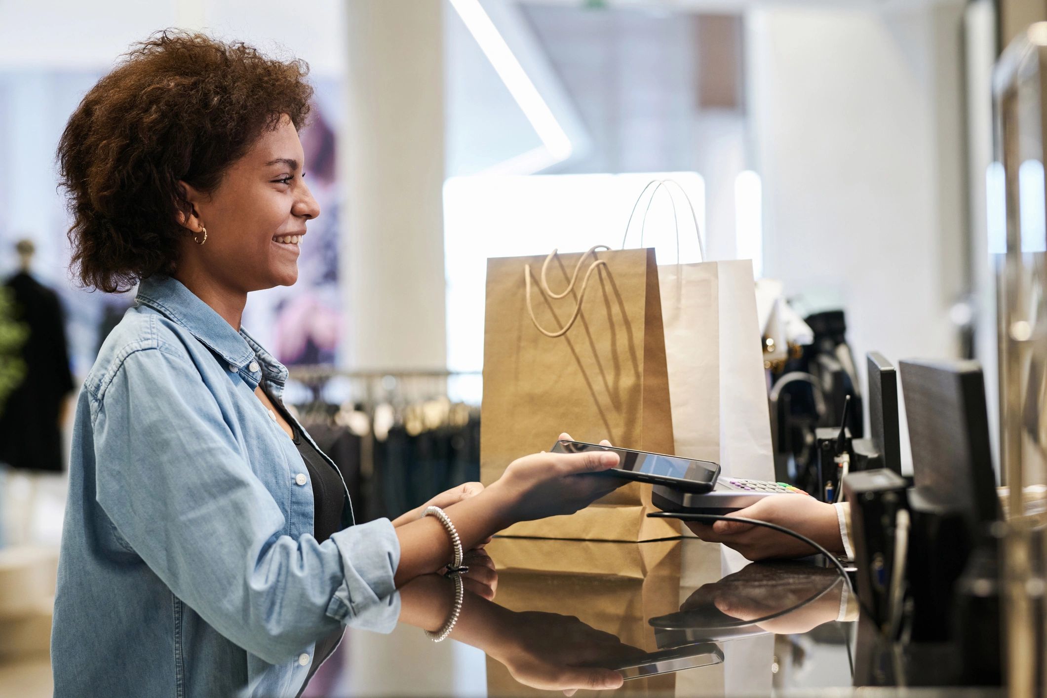 Retail customer using modern payment technology at checkout