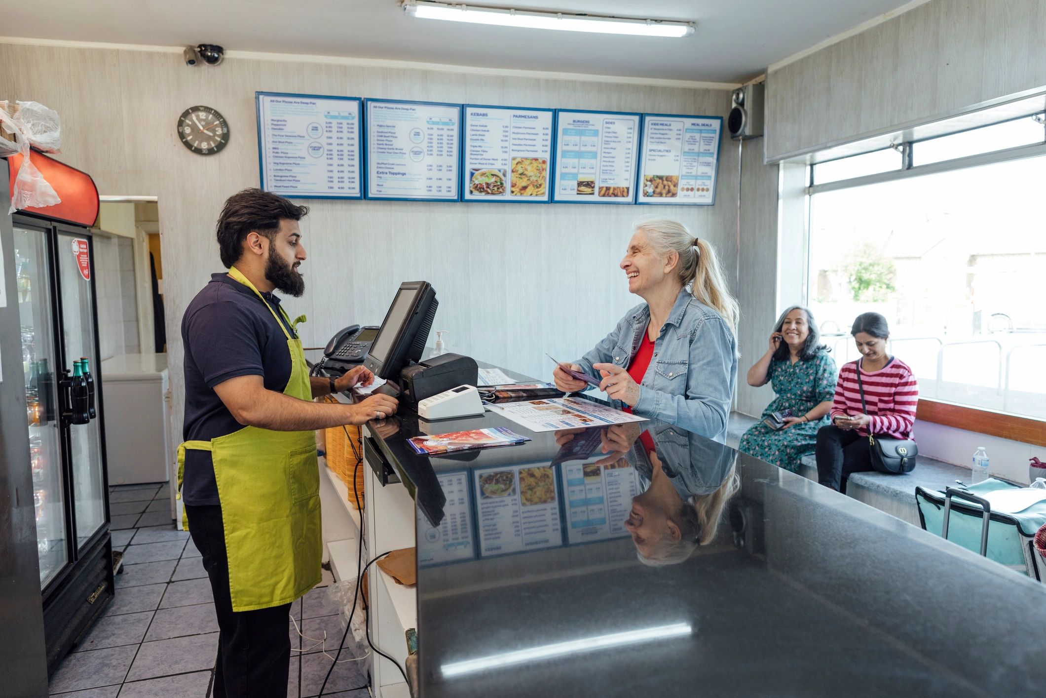 Takeaway counter with staff taking food orders