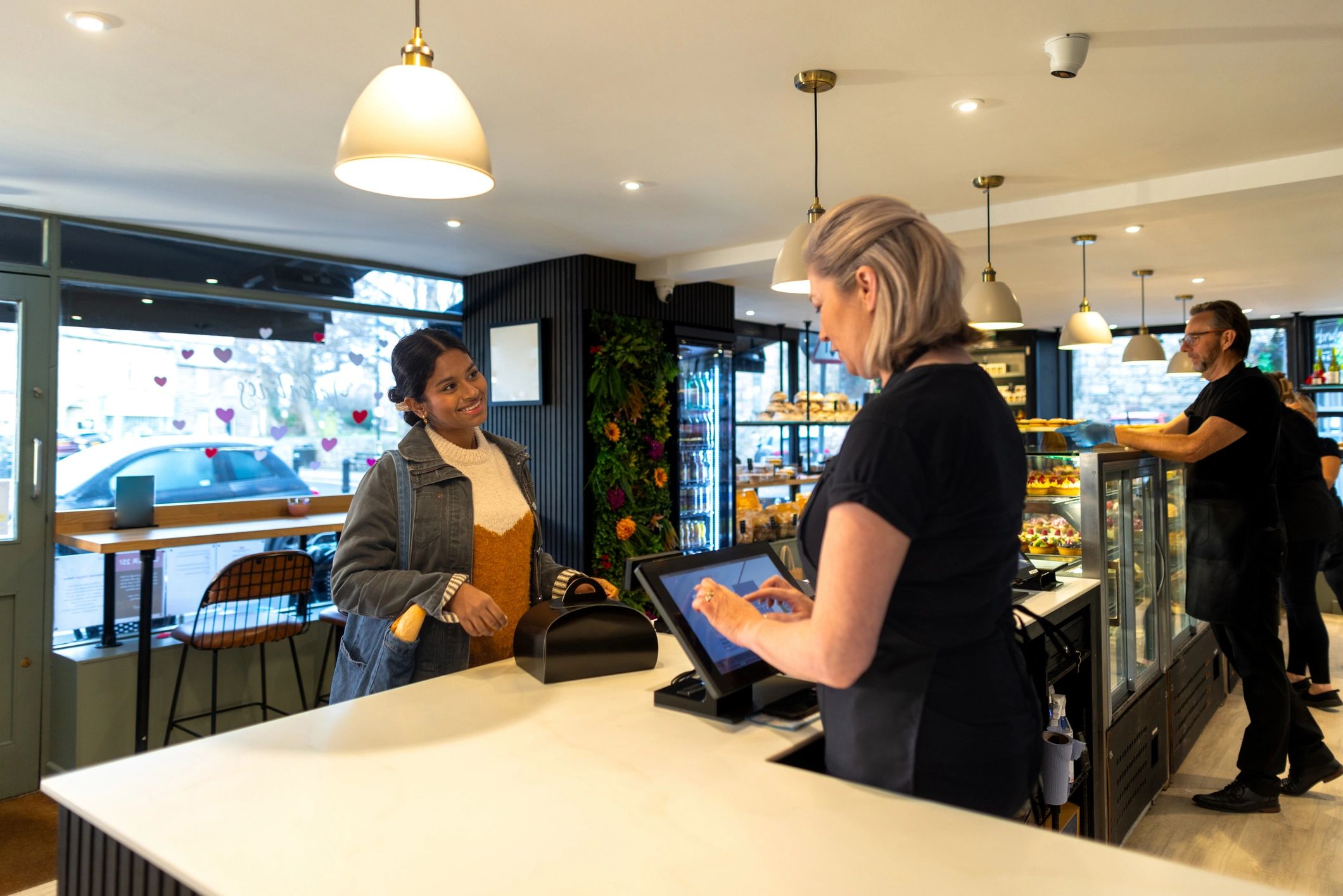 Customer paying at retail checkout counter