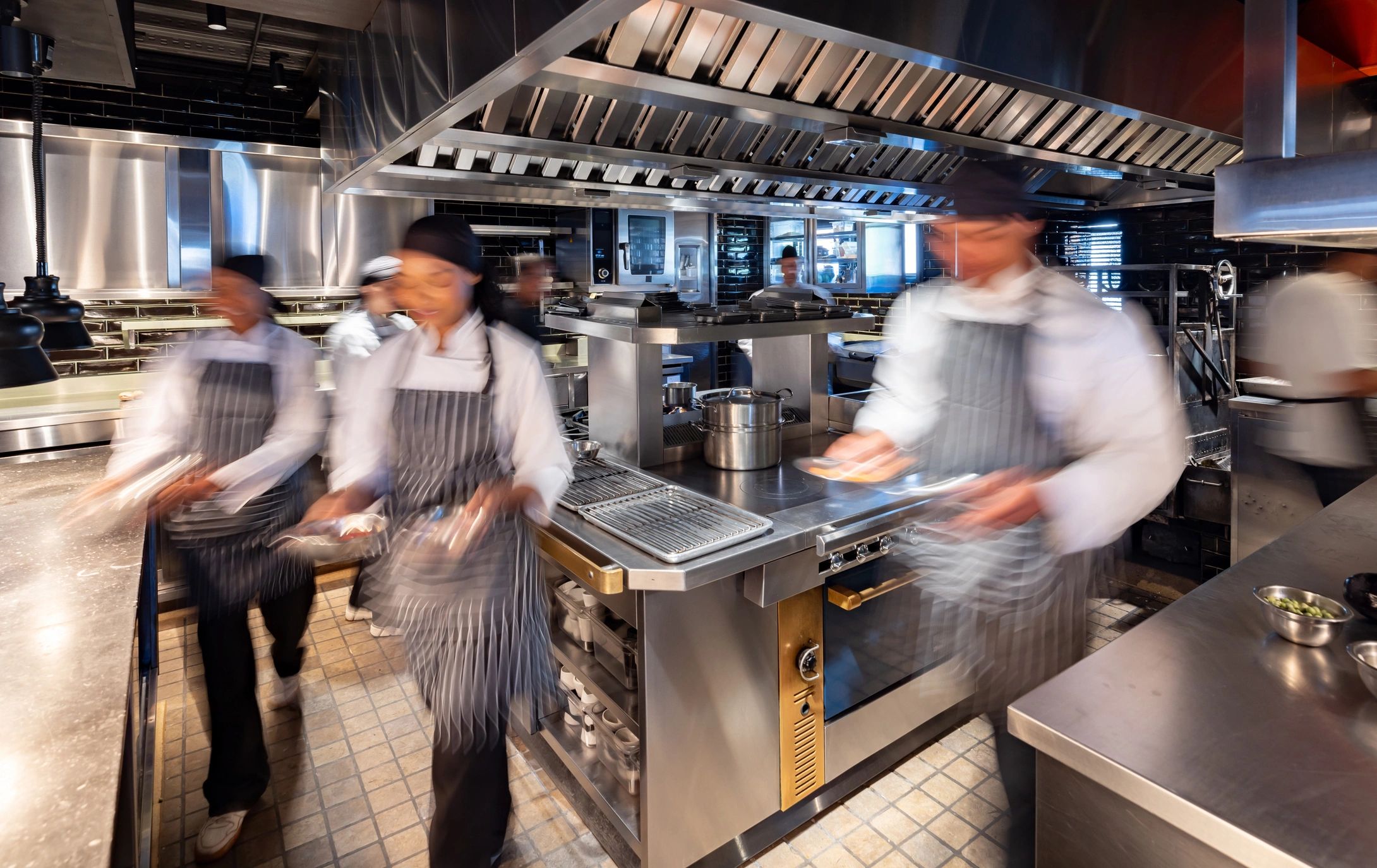 Busy commercial kitchen team during service
